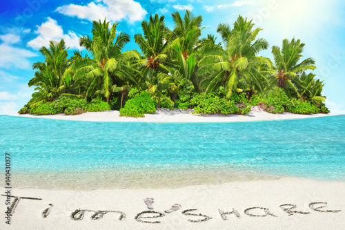 Whole tropical island within atoll in tropical Ocean and inscription "TimeShare" in the sand on a tropical island, Maldives.