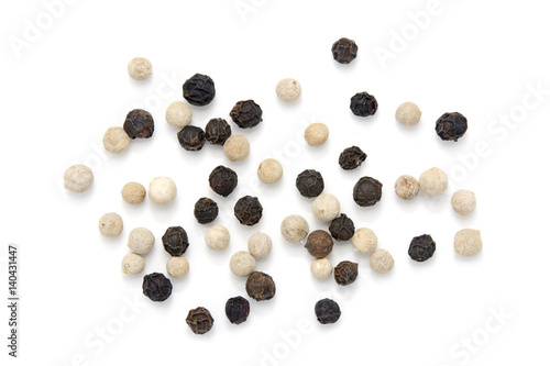 Black and white peppercorns on white background
