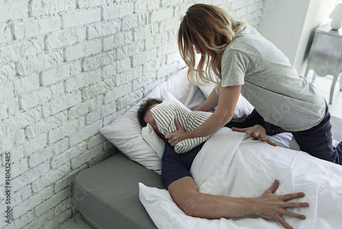 Angry woman choking male person