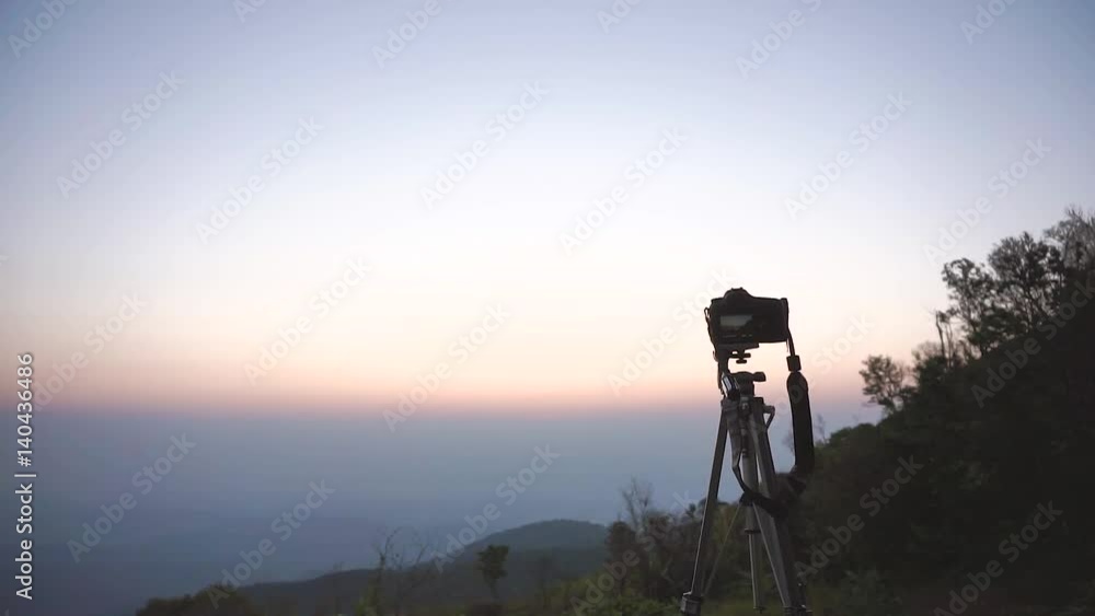 A camera capturing sunrise at mountain view of Asian country A camera capturing sunrise at mountain view of Asian country