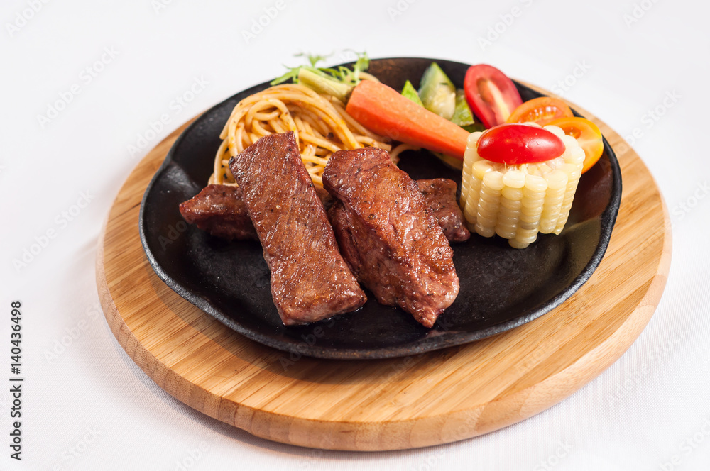 grilled steak with vegetables and noodles