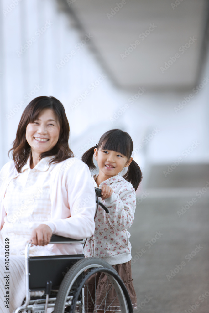 Granddaughter Pushing Grandmother on Wheelchair Granddaughter Pushing Grandmother on Wheelchair