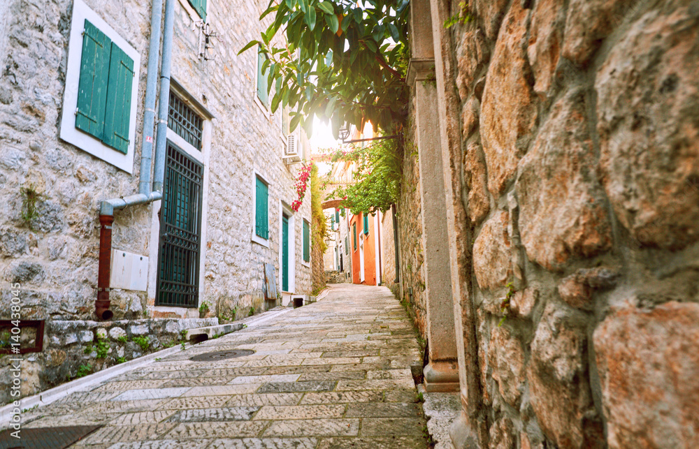 Fototapeta premium Narrow streets of historical old town Herceg Novi, Boka Kotor gilf. Popular touristic route to Kanli Kula fortress, Montenegro.