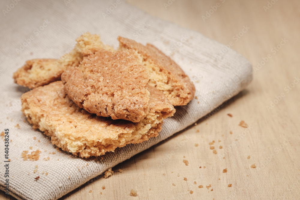 Pastry biscuits on linen napkin on wooden table Pastry biscuits on linen napkin on wooden table