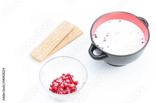 Healthy breakfast consisting of cereal with milk, berries and grain loaves