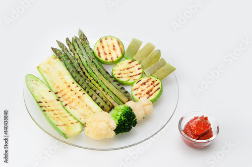Wallpaper Mural Grilled zucchini and asparagus, broccoli, lobi and cauliflower on a glass plate with red sauce Torontodigital.ca