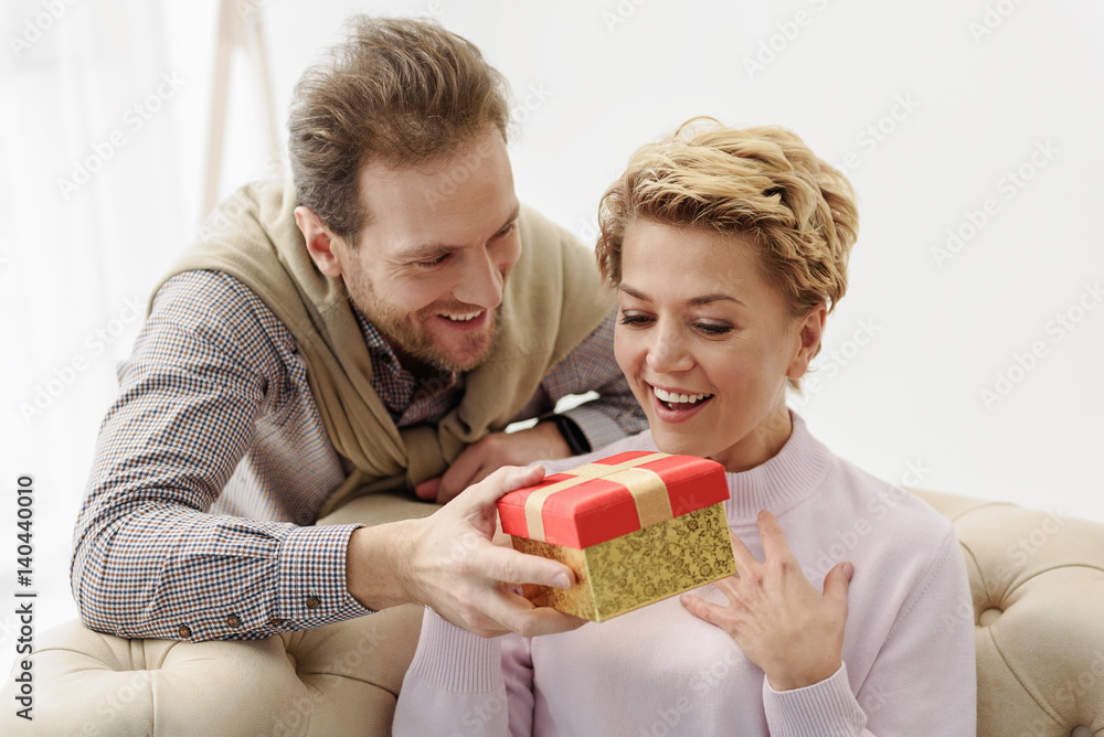Caring man giving present to his wife