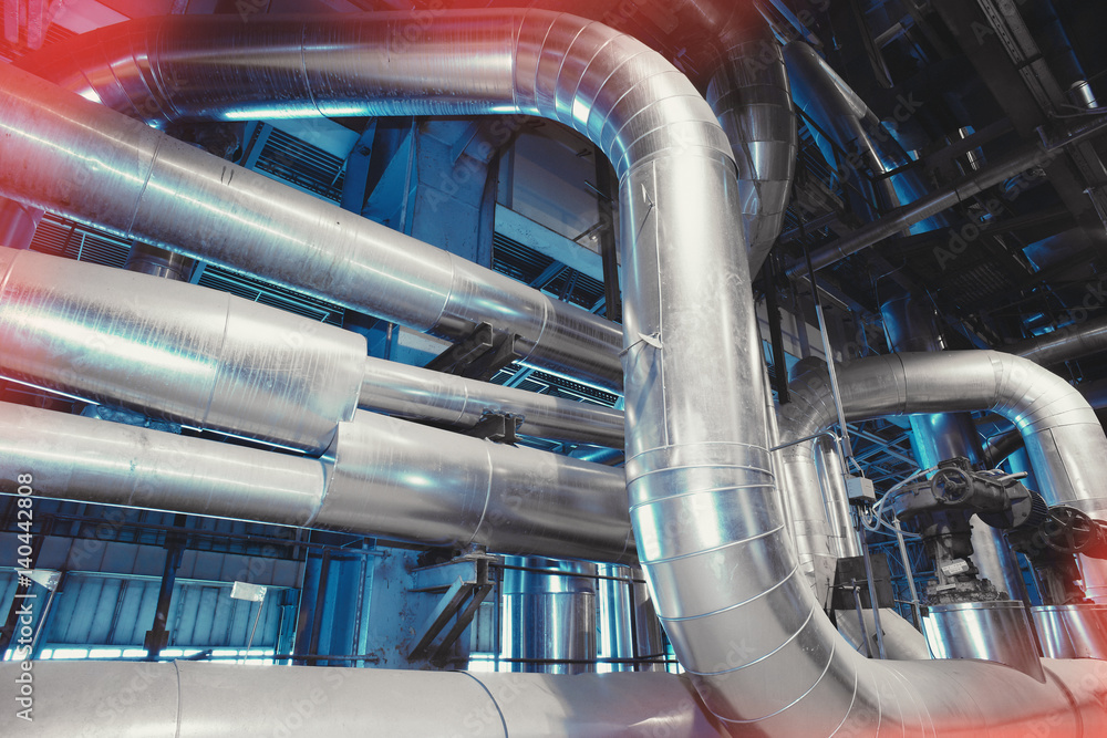 Equipment, cables and piping as found inside of a modern industrial power plant Equipment, cables and piping as found inside of a modern industrial power plant
