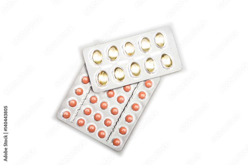 Red pills and capsules of cod-liver oil in blisters Red pills and capsules of cod-liver oil in blisters