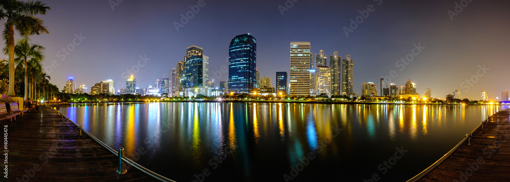 Bangkok city downtown at night with reflection of skyline.