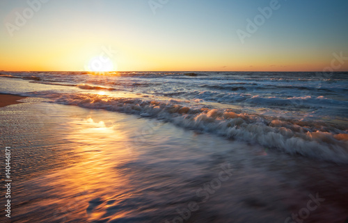 Sunset and ocean. Beach and sea at sunrise.