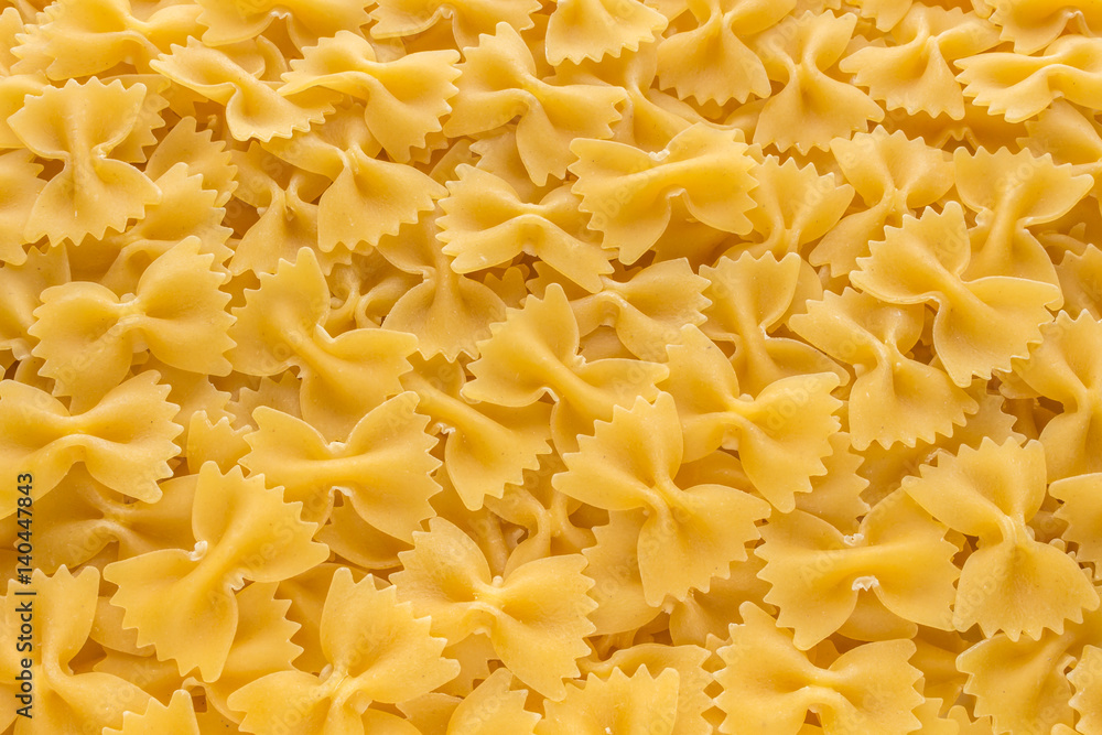 Food background made of raw Farfalle noodles