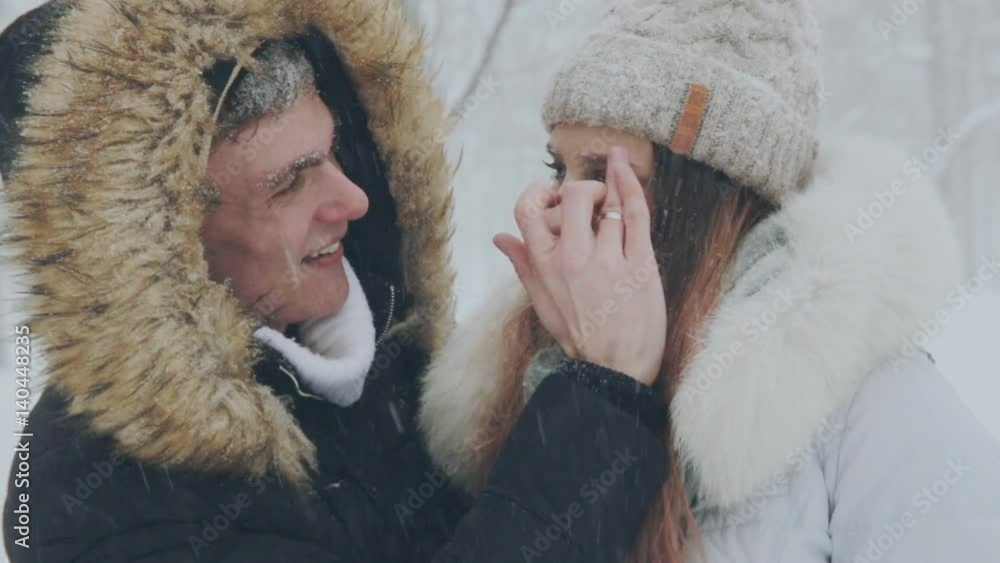 young couple in love in the snow-covered forest young couple in love in the snow-covered forest