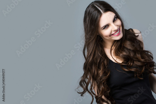 Smiling Woman on a gray background.