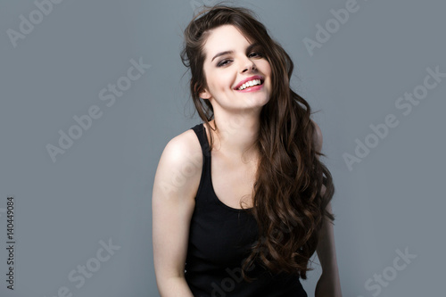 Smiling Woman on a gray background.