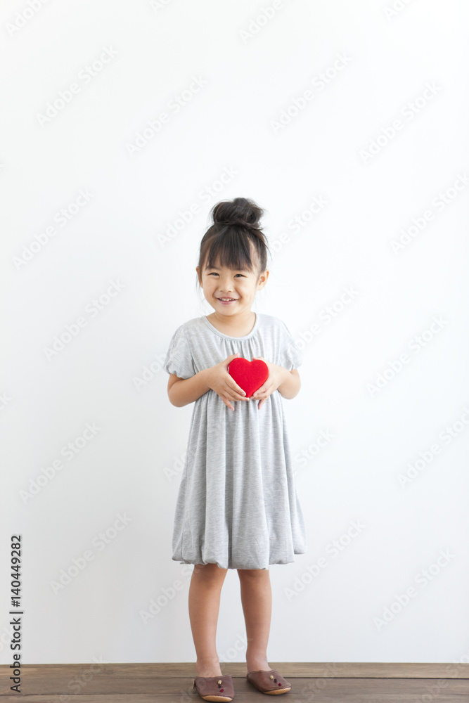 Portrait of girl holding red heart, white background Portrait of girl holding red heart, white background