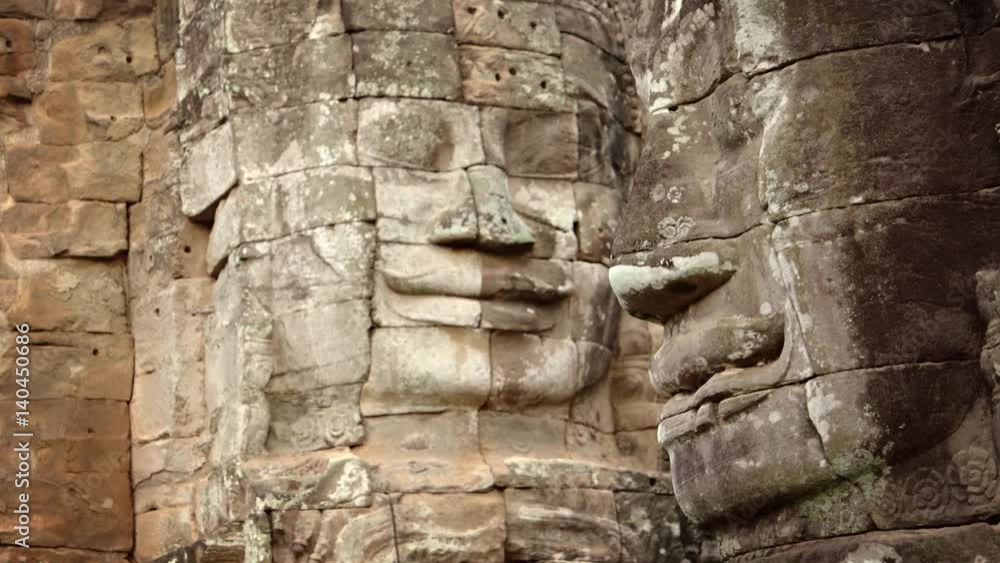 Ancient, Hand-carved stone faces at Bayon Temple in Cambodia Ancient, Hand-carved stone faces at Bayon Temple in Cambodia