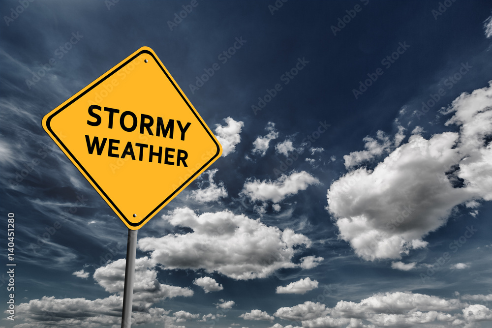 Dark blue cloudy sky and yellow road sign Dark blue cloudy sky and yellow road sign