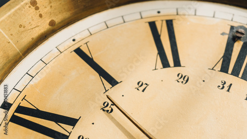 Fototapeta Naklejka Na Ścianę i Meble -  Close-up of Roman numerals on the dial of the wall clock.