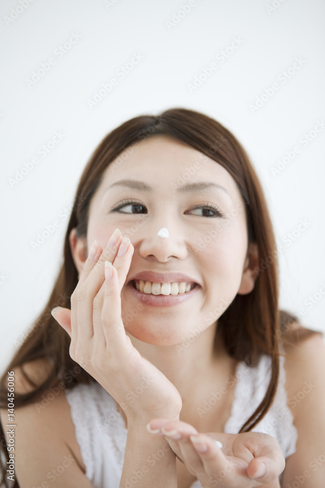 Young Woman Applying Moisturizer Young Woman Applying Moisturizer