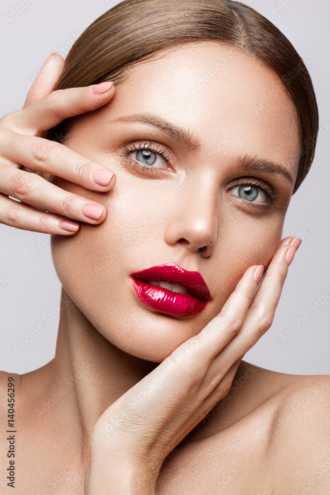 Beautiful young model with red lips and nude manicure Beautiful young model with red lips and nude manicure