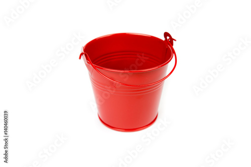 Red iron bucket with handle isolated on white background. Empty metal pail. Colorful kid child toys. Garden equipment. Red container. Handle down, side view. © InspiringMoments