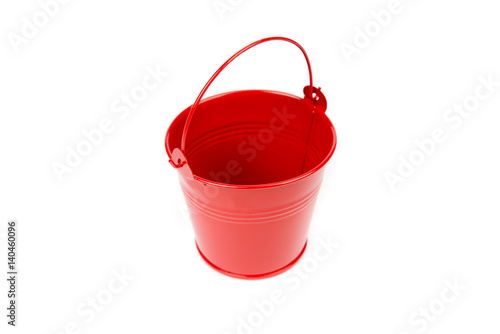 Red iron bucket with handle isolated on white background. Empty metal pail. Colorful kid child toys. Garden equipment. Red container. Handle down, top, side view.