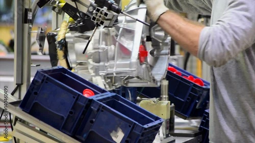 Worker assemble a car gear parts
