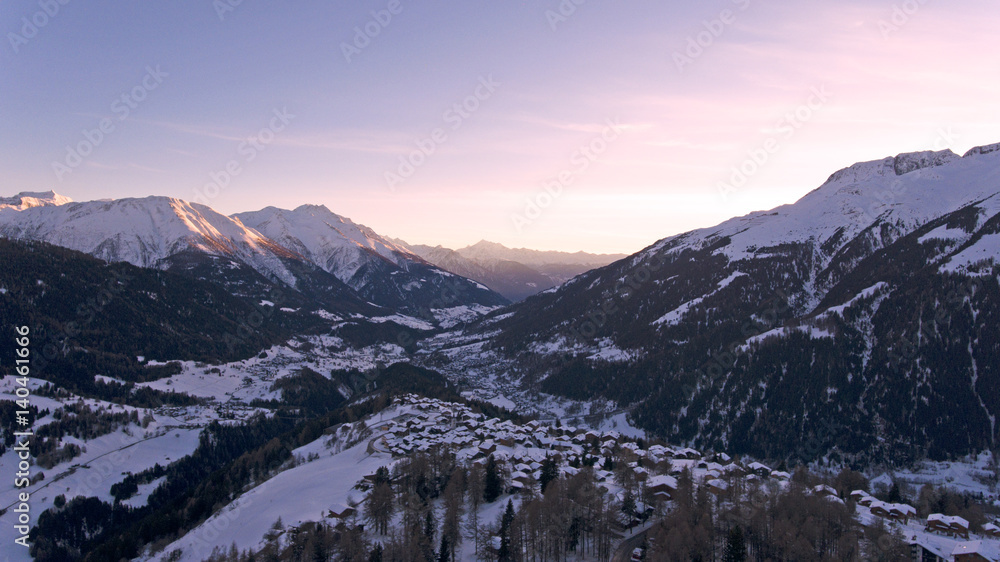 Swiss Alpine village and mountains at sunset