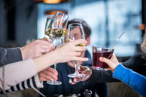 Merry company celebrates victory. Grope of people Clink glasses