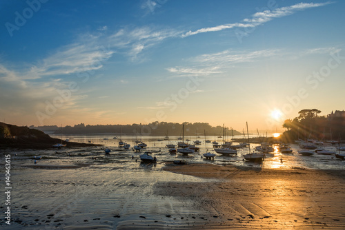 Sailboats at low tide and sunset on the beach of Saint Briac near Saint Malo, Brittany, France © Delphotostock