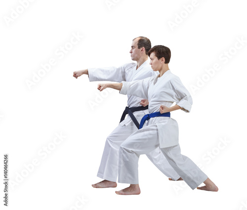 Sister and brother are beating a punch arm on a white background isolated