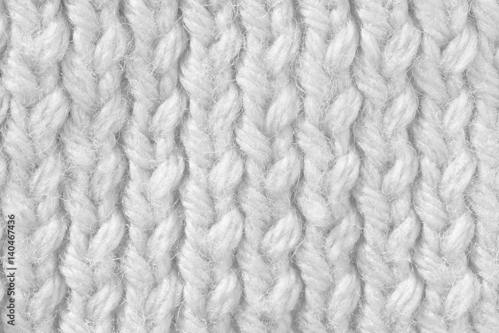 Knitted texture of white color. Hand-made knitting needles for postcard background. Winter cozy thing. Knitted texture of white color. Hand-made knitting needles for postcard background. Winter cozy thing.