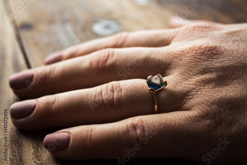 woman's hand with an engagement ring