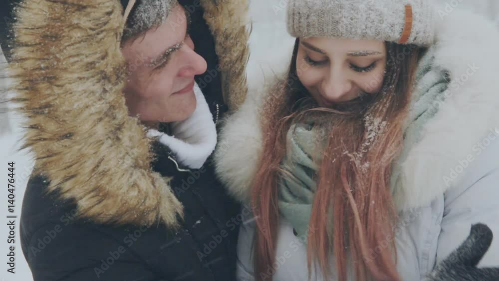 young couple in love in the snow-covered forest young couple in love in the snow-covered forest