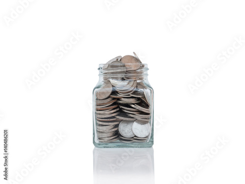 Glass jars with coins on reflective surface isolated on white.