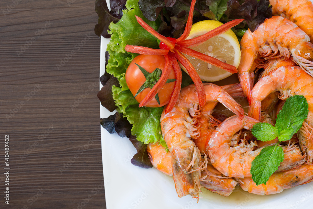 Shrimp boiled with honey and salt in white dish on dark table thai food Shrimp boiled with honey and salt in white dish on dark table thai food