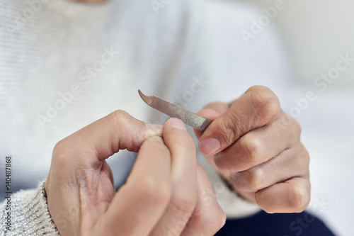 Tela young man polishing his fingernails
