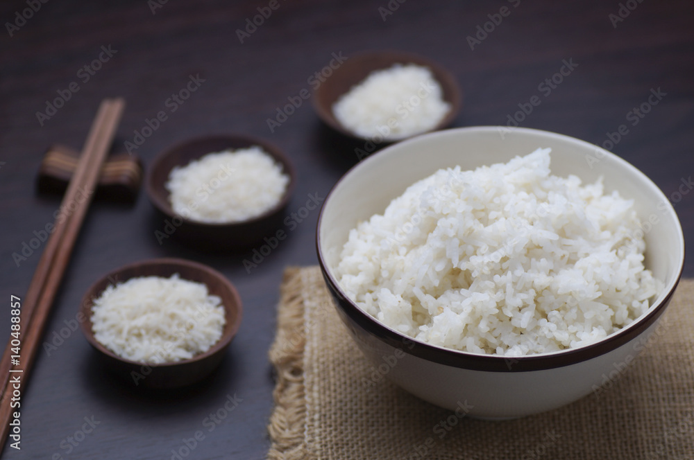 Thai rice with chopsticks on wood background Thai rice with chopsticks on wood background