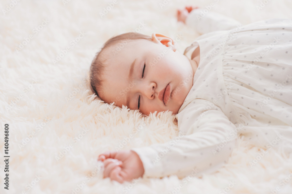 Close-up portrait cute baby lying on a fur blanket while sleeping Close-up portrait cute baby lying on a fur blanket while sleeping
