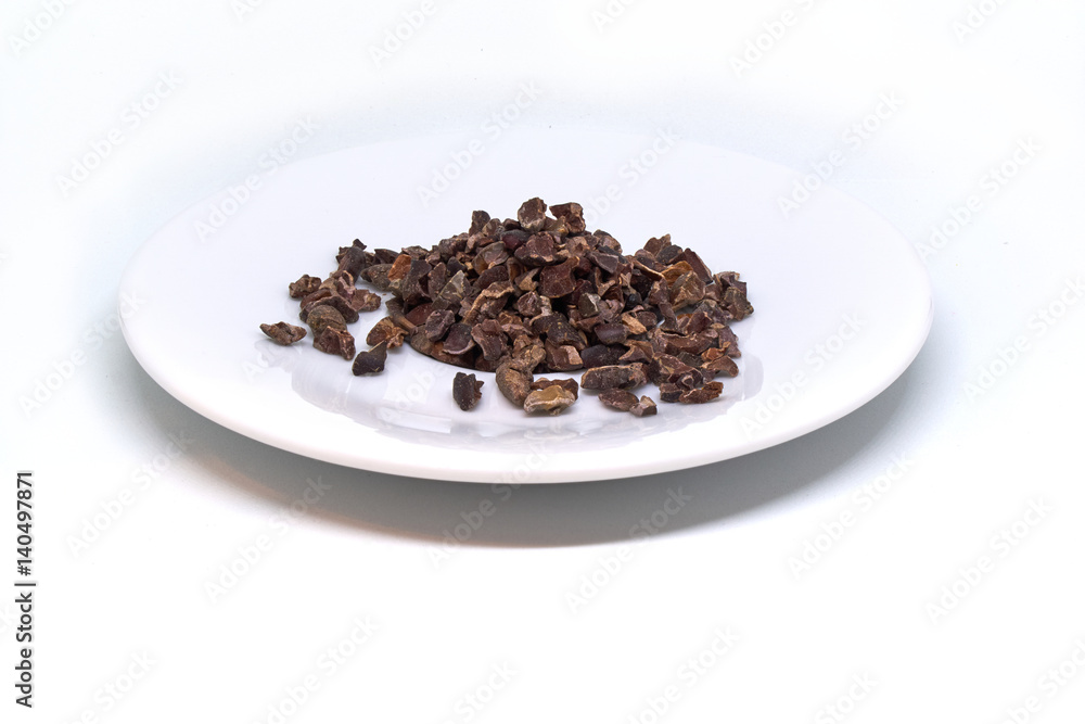 cacao nibs on a plate isolated cacao nibs on a plate isolated