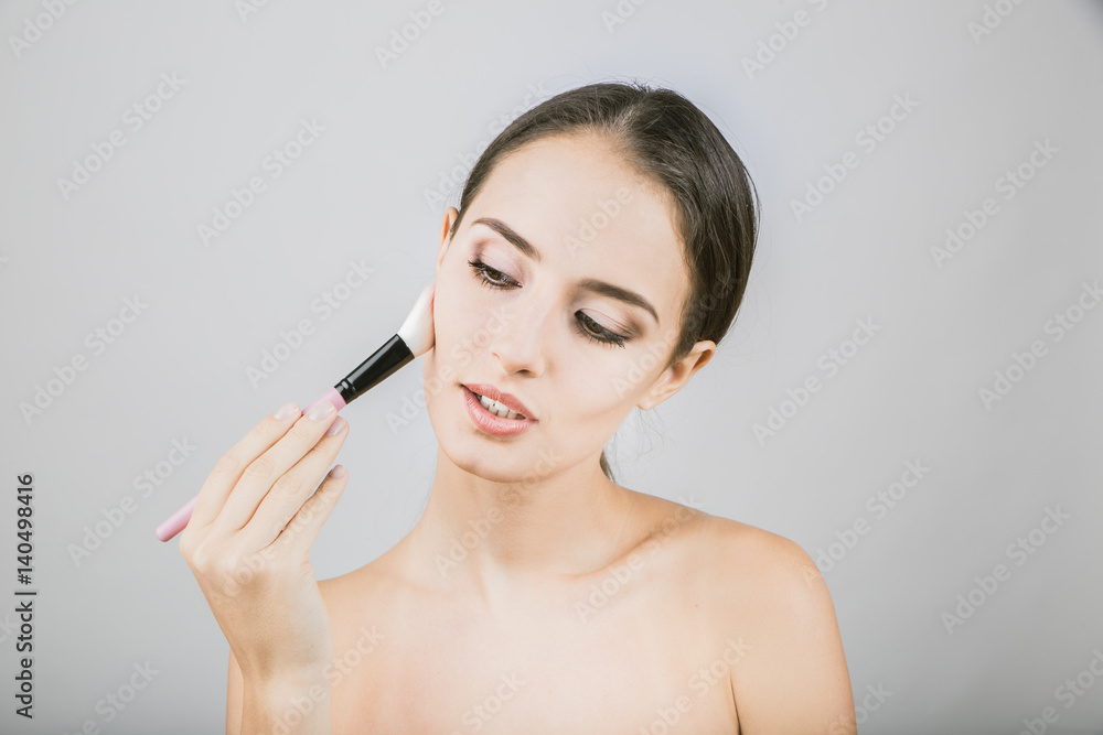 Beauty portrait of young, attractive, fresh, healthy and natural woman with the makeup brush Beauty portrait of young, attractive, fresh, healthy and natural woman with the makeup brush