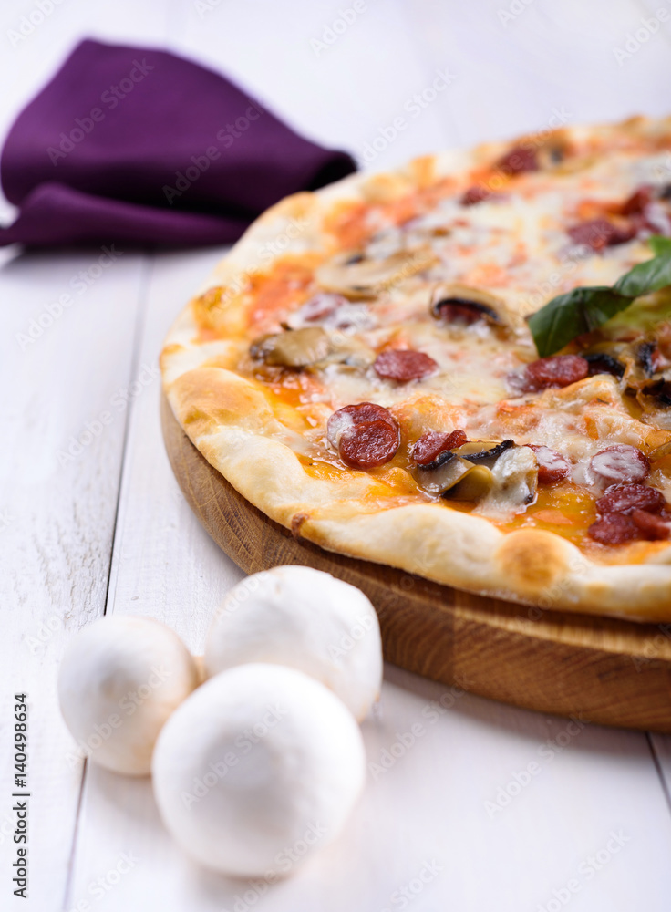 Pizza with mushrooms on a wooden board Pizza with mushrooms on a wooden board