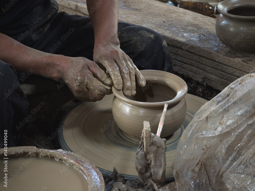 Master are molding clay to make earthenware