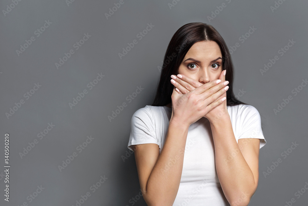 Scared woman covering mouth with hands Scared woman covering mouth with hands