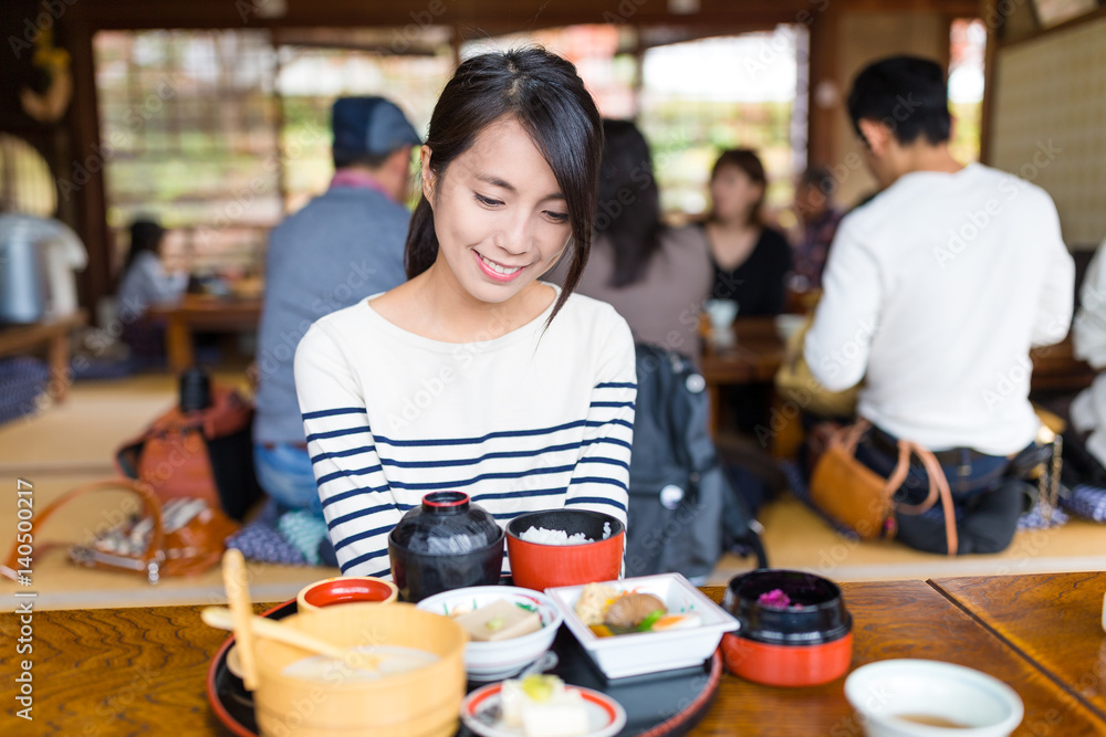 Woman enjoy her dish in Japanese style restaurant