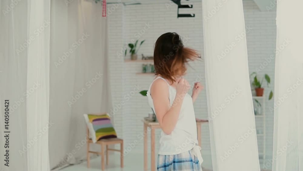 Beautiful young woman feeling happy, playing with hair. Brunette girl in pajamas spinning. Slow motion. Beautiful young woman feeling happy, playing with hair. Brunette girl in pajamas spinning. Slow motion.