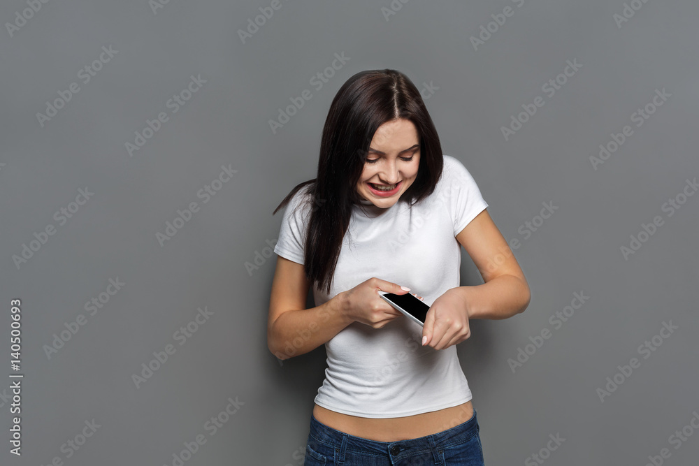 Furious girl trying to break mobile phone Furious girl trying to break mobile phone