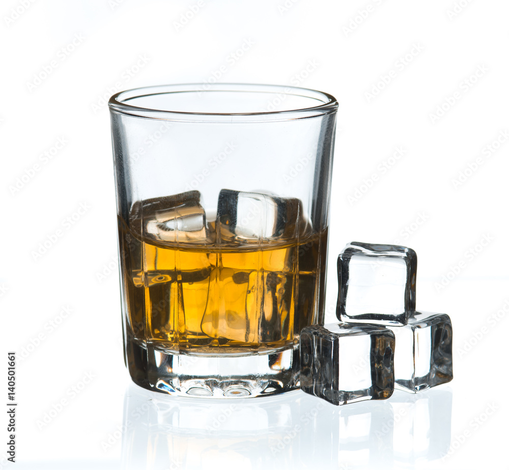 Glass of whisky with ice on a white Glass of whisky with ice on a white
