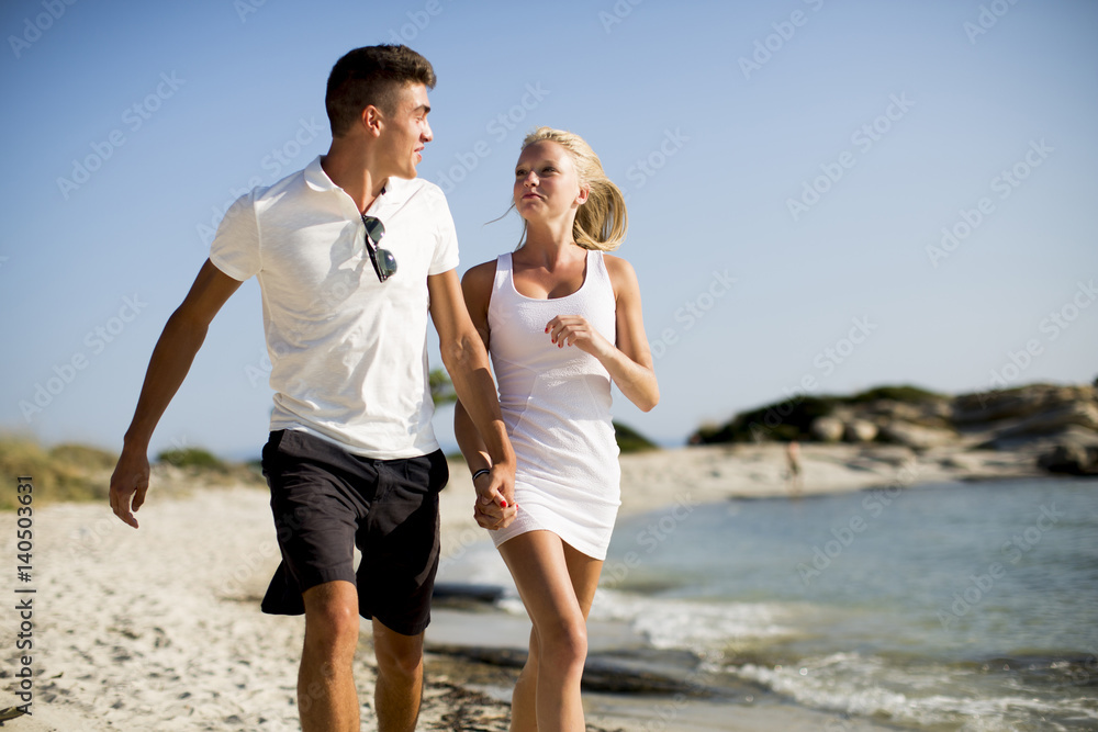 Loving couple walking on the beach Loving couple walking on the beach